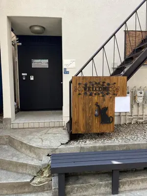 a bench in front of a building with graffiti on it at Cozy inn \u897f\u54c1\u5ddd101 in Tokyo