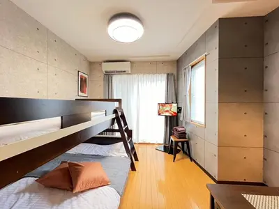 a bedroom with two bunk beds and a table at Amika First203 AF23 in Tokyo