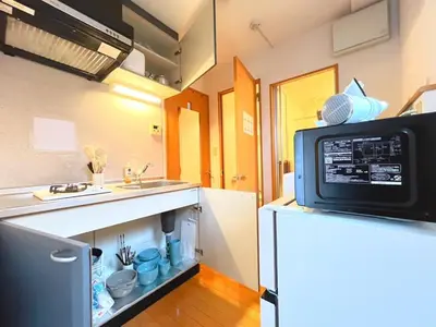 a small kitchen with a refrigerator and a microwave at Amika First203 AF23 in Tokyo