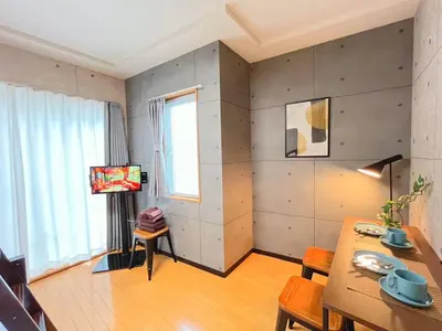 a living room with a table and a television at Amika First203 AF23 in Tokyo