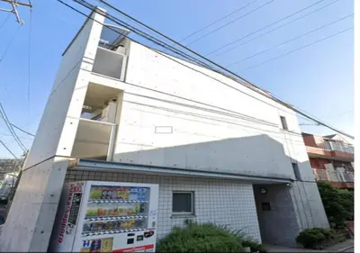 a white building with a vending machine in front of it at Amika First203 AF23 in Tokyo