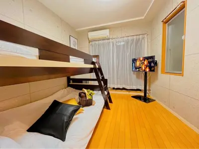 a bedroom with a bunk bed and a flat screen tv at Amika First102 AF12 in Tokyo