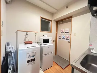 a kitchen with a refrigerator and a microwave at Amika First102 AF12 in Tokyo