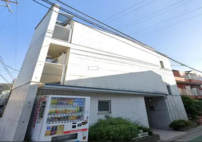 a white building with a refrigerator in front of it at Amika First102 AF12 in Tokyo