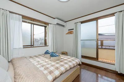 a bedroom with a bed and a large window at Asakusa-Ginza-Skytree-Stn-4min-95sqm-Garage-2WC-2Swr in Tokyo