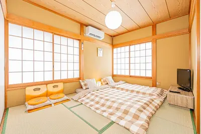 a bedroom with a large bed and a tv at Asakusa-Ginza-Skytree-Stn-4min-95sqm-Garage-2WC-2Swr in Tokyo