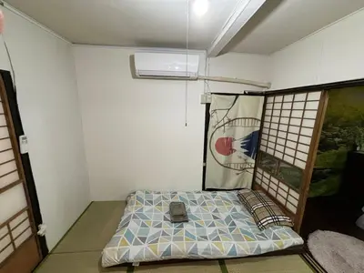 a small room with a bed and a window at Yuki House in Tokyo