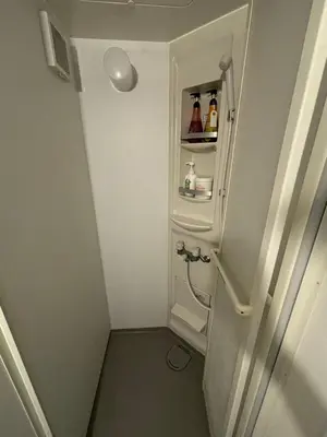 a small bathroom with a toilet and a shelf at Yuki House in Tokyo