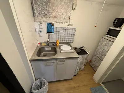 a small kitchen with a sink in a room at Yuki House in Tokyo