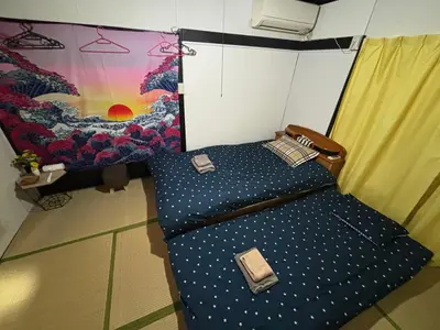 a chair in a room with a painting on the wall at Yuki House in Tokyo