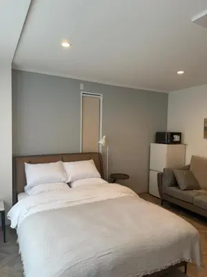 a bedroom with a large bed and a couch at the one ueno in Tokyo