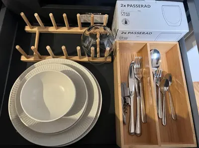 a plate and utensils in a wooden box at the one ueno in Tokyo