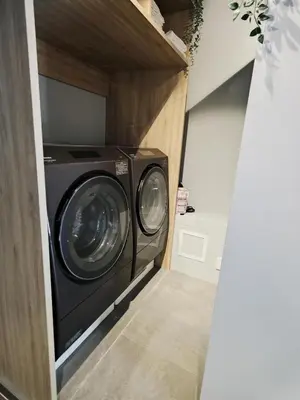 a laundry room with a washer and dryer at the one ueno in Tokyo