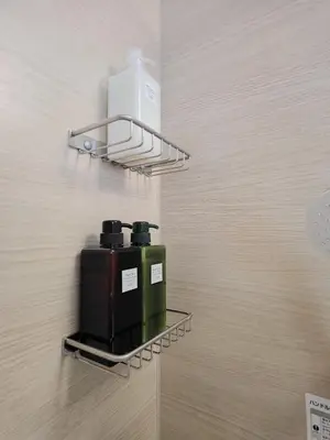 a wall mounted shelf with two bottles on a wall at the one ueno in Tokyo