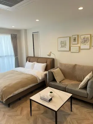 a living room with a bed and a couch at the one ueno in Tokyo