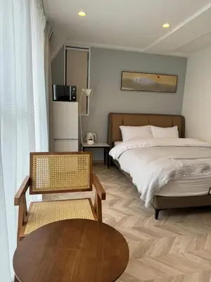 a bedroom with a bed and a coffee table at the one ueno in Tokyo