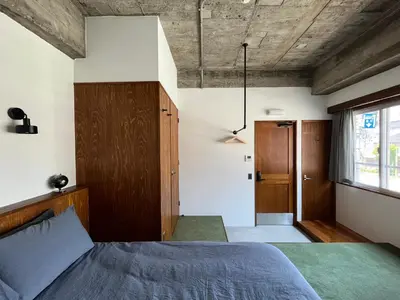 a bedroom with a bed and a wooden ceiling at NO SERVICE HOTEL azumabashi in Tokyo