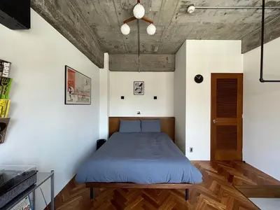 a bedroom with a bed with a wooden floor at NO SERVICE HOTEL azumabashi in Tokyo