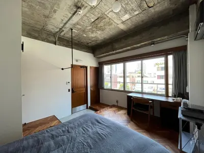 a bedroom with a bed and a desk and a window at NO SERVICE HOTEL azumabashi in Tokyo