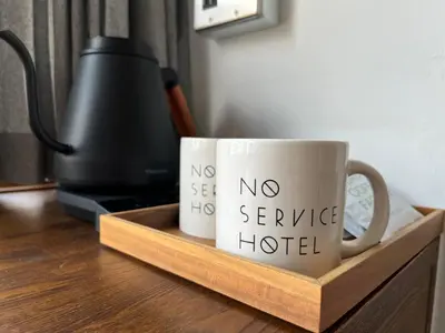 a couple of coffee cups sitting on a wooden tray at NO SERVICE HOTEL azumabashi in Tokyo