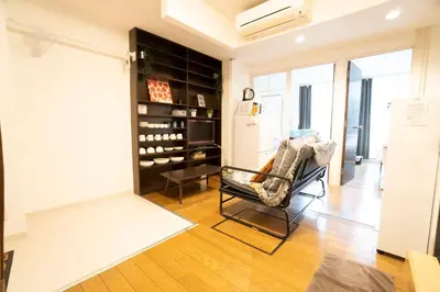 a living room with a chair and a wine cellar at Jarudan in Tokyo