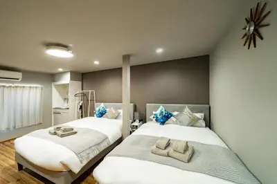 two beds sitting next to each other in a room at 74, Yotsugi, Entire house for rent, \u56db\u3064\u6728 in Tokyo