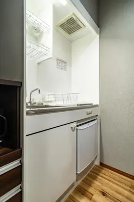 a white kitchen with a sink and a dishwasher at 74, Yotsugi, Entire house for rent, \u56db\u3064\u6728 in Tokyo