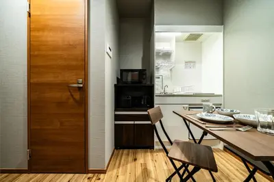 a kitchen and dining room with a wooden table and chairs at 74, Yotsugi, Entire house for rent, \u56db\u3064\u6728 in Tokyo
