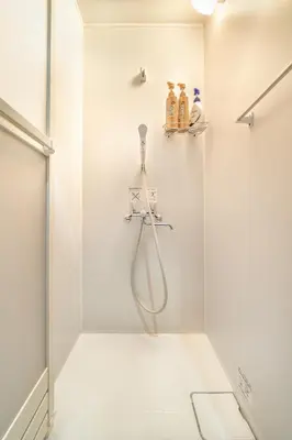 a shower in a bathroom with a glass door at 74, Yotsugi, Entire house for rent, \u56db\u3064\u6728 in Tokyo