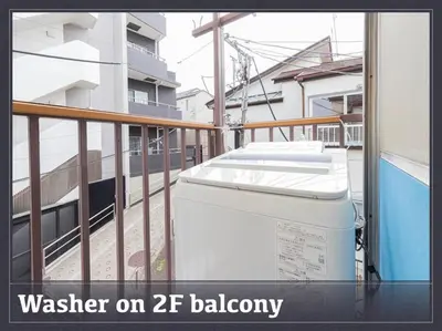 a washing machine on a balcony of a building at Discover Tokyo's soul Your cozy Japanese escape! in Tokyo
