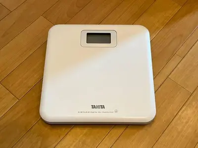 a white electronic device sitting on a wooden floor at Discover Tokyo's soul Your cozy Japanese escape! in Tokyo