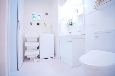 a white bathroom with a toilet and a sink at #40 -Siro House- \u5800\u5207 in Tokyo