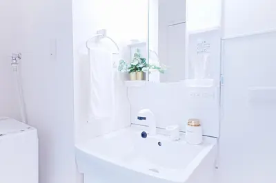 a white bathroom with a sink and a mirror at #40 -Siro House- \u5800\u5207 in Tokyo