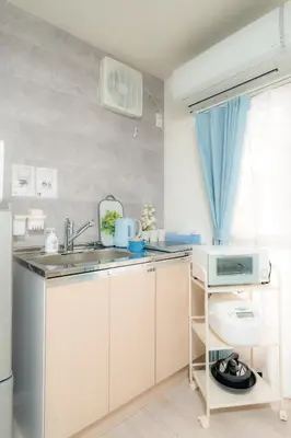 a small kitchen with a sink and a microwave at 20, Hikifune, Entire house for rent, \u66f3\u821f in Tokyo
