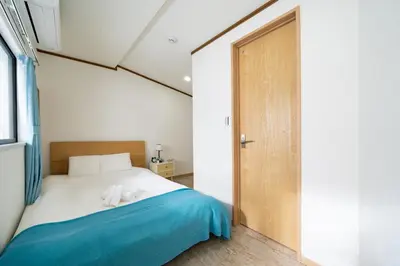 a bedroom with a bed with two white towels on it at 38, Kyojima 3, Entire house for rent, \u4eac\u5cf63\u4e01\u76ee in Tokyo