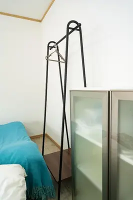 a black floor lamp next to a bed at 38, Kyojima 3, Entire house for rent, \u4eac\u5cf63\u4e01\u76ee in Tokyo