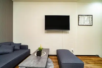 a living room with a couch and a tv on the wall at 72, Nakanobu A, Entire house for rent, \u4e2d\u5ef6A in Tokyo
