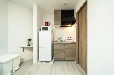 a kitchen with a white refrigerator and a sink at 83, Higashi-Yotsugi 3, Entire house for rent in Tokyo