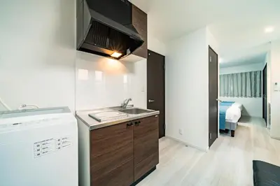 a small kitchen with a sink and a microwave at 83, Higashi-Yotsugi 3, Entire house for rent in Tokyo