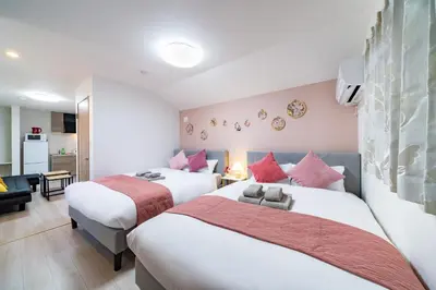 a bedroom with two beds and a living room at 83, Higashi-Yotsugi 3, Entire house for rent in Tokyo