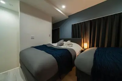 a hotel room with two beds and a window at 96, Tateishi A, Entire house for rent, \u7acb\u77f3A in Tokyo