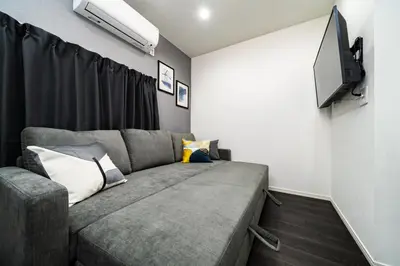 a living room with a couch and a flat screen tv at 96, Tateishi A, Entire house for rent, \u7acb\u77f3A in Tokyo