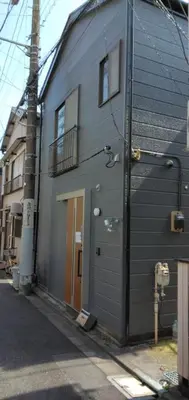 a gray building with a door on a street at 96, Tateishi A, Entire house for rent, \u7acb\u77f3A in Tokyo