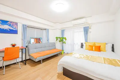 a bedroom with a bed and a chair and a couch at KYARA Hotel\u30df\u30b9\u30df202 in Tokyo