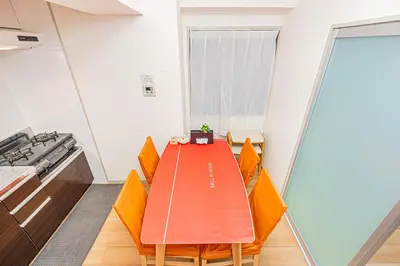 a dining room with a table and chairs at KYARA Hotel\u30df\u30b9\u30df202 in Tokyo