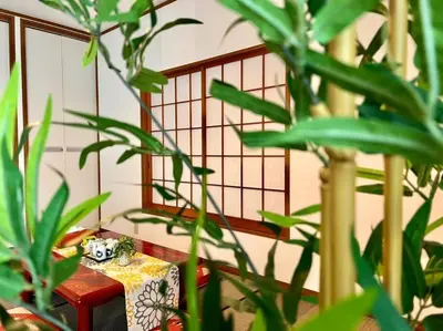 a table in a room with some plants at FUKU House in Tokyo