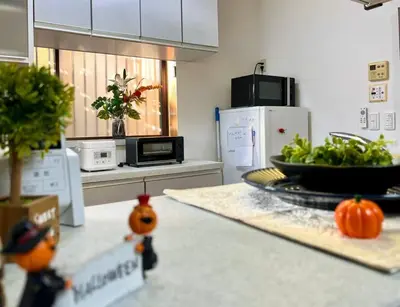 a kitchen with a counter with a bowl of vegetables at FUKU House in Tokyo