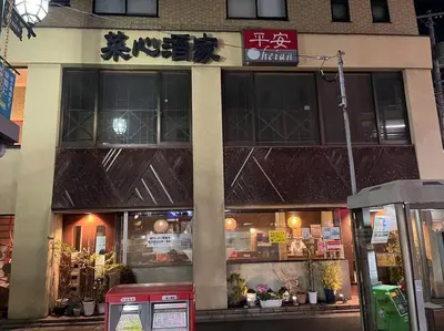 a restaurant with a sign on the front of a building at FUKU House in Tokyo
