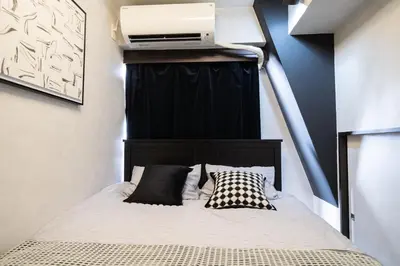 a bedroom with a bed with a heater on the wall at G112\u65b0\u5bbf\u6700\u4e2d\u5fc3 \u4ea4\u901a\u67a2\u7ebd \u8d85\u7ea7\u5546\u5708 \u4e24\u5ba4\u4e00\u5385 \u65b0\u5bbf\u4e09\u4e01\u76ee\u8f66\u7ad94\u5206 2 rooms Shinjuku center 4 mins to ST Max 7P \u76f4\u8fbe\u65b0\u5bbf \u6d89\u8c37 \u8868\u53c2\u9053 \u6c60\u888b \u4e0a\u91ce \u4ee3\u4ee3\u6728 \u94f6\u5ea7 \u539f\u5bbf in Tokyo