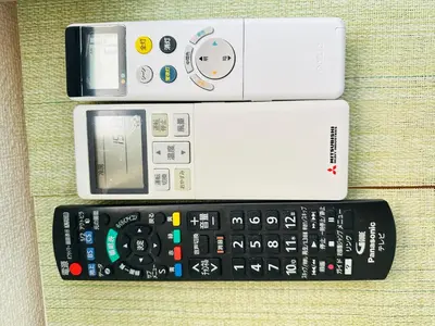 a group of remote controls sitting on a couch at \u30b7\u30e3\u30f3\u30c6\u9ad8\u7530\u99ac\u583432 in Tokyo